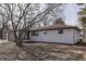 Side view of a freshly painted white brick ranch home with a patio at 5324 Mann Rd, Indianapolis, IN 46221