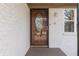 Modern front door with glass oval accent and light brown finish at 5324 Mann Rd, Indianapolis, IN 46221