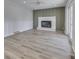 Gathering room boasts a fireplace, wood floors, and backyard access at 5324 Mann Rd, Indianapolis, IN 46221