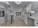 Bright kitchen with stainless steel appliances and view into living room at 5324 Mann Rd, Indianapolis, IN 46221