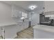 Updated kitchen with white cabinets, quartz countertops, and stainless steel appliances at 5324 Mann Rd, Indianapolis, IN 46221