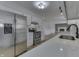 Renovated kitchen boasts stainless steel appliances and white cabinetry at 5324 Mann Rd, Indianapolis, IN 46221