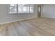 Hardwood floors and large windows fill this sunlit living room at 5324 Mann Rd, Indianapolis, IN 46221