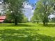 Expansive backyard with mature trees, offering a serene and private outdoor space at 5324 Mann Rd, Indianapolis, IN 46221
