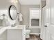 Clean bathroom with white vanity, toilet, and shower at 5704 E 16Th St, Indianapolis, IN 46218