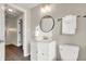 Small bathroom with white vanity, toilet and updated fixtures at 5704 E 16Th St, Indianapolis, IN 46218