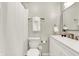 Clean bathroom with white vanity, shower, and toilet at 5704 E 16Th St, Indianapolis, IN 46218