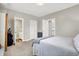 Spacious bedroom with a queen bed, carpet flooring, and access to bathroom and hallway at 5704 E 16Th St, Indianapolis, IN 46218