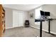 Spacious home office with standing desk, comfortable chair, and ample storage at 5704 E 16Th St, Indianapolis, IN 46218