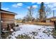 House exterior with wood siding and snowy backyard at 5704 E 16Th St, Indianapolis, IN 46218