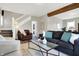 Living room with hardwood floors, staircase, and comfortable seating area at 5704 E 16Th St, Indianapolis, IN 46218