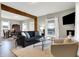 Open living room featuring a dark couch, accent chairs, and hardwood flooring at 5704 E 16Th St, Indianapolis, IN 46218