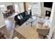 Bright living room with comfy seating, hardwood floors, and a dining area at 5704 E 16Th St, Indianapolis, IN 46218