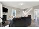 Living room showcasing a dark sofa, hardwood floors, and a staircase at 5704 E 16Th St, Indianapolis, IN 46218