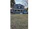 Green two-story house with a spacious lawn and attached garage at 5844 Central Ave, Indianapolis, IN 46220