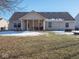 Backyard with covered patio and snow at 6264 Whitaker Farms Dr, Indianapolis, IN 46237