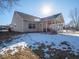 Backyard with covered patio and snowy ground at 6264 Whitaker Farms Dr, Indianapolis, IN 46237