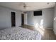 Main bedroom with hardwood floors, ceiling fan, and access to bathroom at 6264 Whitaker Farms Dr, Indianapolis, IN 46237
