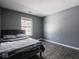 Bedroom with bed, window, and grey walls at 6264 Whitaker Farms Dr, Indianapolis, IN 46237