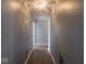 Light-filled hallway with hardwood floors and simple decor at 6264 Whitaker Farms Dr, Indianapolis, IN 46237