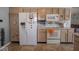 Bright kitchen with oak cabinets, white appliances, and decorative accents at 6264 Whitaker Farms Dr, Indianapolis, IN 46237