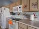 Kitchen with oak cabinets, white appliances and decorative backsplash at 6264 Whitaker Farms Dr, Indianapolis, IN 46237