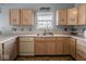 Kitchen boasts oak cabinets, double sink, and tile flooring at 6264 Whitaker Farms Dr, Indianapolis, IN 46237