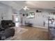 Open living room with hardwood floors, a ceiling fan, and plenty of natural light at 6264 Whitaker Farms Dr, Indianapolis, IN 46237