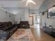 Relaxing living room featuring leather reclining furniture and a view into the kitchen at 6264 Whitaker Farms Dr, Indianapolis, IN 46237