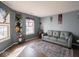Relaxing living room featuring hardwood floors, large windows, and comfy sofa at 6264 Whitaker Farms Dr, Indianapolis, IN 46237