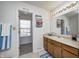 Bright bathroom featuring a large mirror and a window providing natural light at 6623 Pasco Ln, Plainfield, IN 46168
