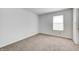 Simple bedroom with soft carpet and a window providing natural light at 6623 Pasco Ln, Plainfield, IN 46168