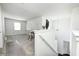 Bright bonus room showcasing an open layout, neutral carpeting, and staircase leading to additional living spaces at 6623 Pasco Ln, Plainfield, IN 46168
