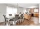 Bright dining room with a table set for six adjacent to an open kitchen featuring stainless steel appliances at 6623 Pasco Ln, Plainfield, IN 46168