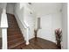 Inviting entryway with wood floors, staircase, and natural light creating a warm and welcoming ambiance at 6623 Pasco Ln, Plainfield, IN 46168