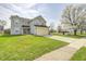 Charming two-story home boasts a lush front lawn, attached garage, and proximity to green spaces at 6623 Pasco Ln, Plainfield, IN 46168