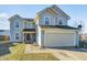Charming two-story home features a two car garage, quaint landscaping, and a welcoming walkway to the front door at 6623 Pasco Ln, Plainfield, IN 46168