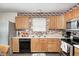 Well-lit kitchen boasts ample cabinet space, modern appliances, and a functional layout for cooking and entertaining at 6623 Pasco Ln, Plainfield, IN 46168