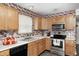 Cozy kitchen featuring wooden cabinets, modern appliances, and decor at 6623 Pasco Ln, Plainfield, IN 46168