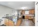 Charming kitchen featuring wood cabinets, a black countertop island, and stainless steel appliances at 6623 Pasco Ln, Plainfield, IN 46168