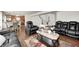 Open-concept living room showcases hardwood floors, a dining area, and leather recliners for ultimate relaxation at 6623 Pasco Ln, Plainfield, IN 46168