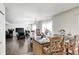 Open-concept living area featuring hardwood floors and an island with seating overlooking living and dining areas at 6623 Pasco Ln, Plainfield, IN 46168