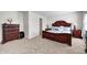 Inviting main bedroom showcasing a carpet, dresser and a large bed with pillows, creating a cozy atmosphere at 6623 Pasco Ln, Plainfield, IN 46168