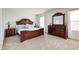 Cozy main bedroom with plush carpeting, a luxurious bed with a dresser and nightstand in a neutral palette at 6623 Pasco Ln, Plainfield, IN 46168