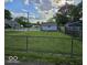 Large, grassy backyard enclosed by a chain-link fence, offering ample space at 733 S Emerson Ave, Indianapolis, IN 46203