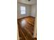 Bright bedroom featuring hardwood floors and a large window at 733 S Emerson Ave, Indianapolis, IN 46203