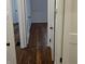 Hardwood floors and white doors in the hallway at 733 S Emerson Ave, Indianapolis, IN 46203