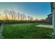 Large backyard with lush green grass, fenced perimeter, and mature trees, ideal for relaxation and entertainment at 9812 Ridgecrest Ln, McCordsville, IN 46055