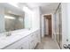 Bright bathroom with double sinks, neutral flooring, and a glass shower with seating at 9812 Ridgecrest Ln, McCordsville, IN 46055