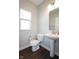 Bright bathroom with a pedestal sink, new toilet, and modern fixtures at 9812 Ridgecrest Ln, McCordsville, IN 46055